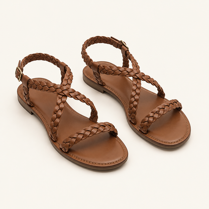 Illustrative pair of brown braided flat sandals on a light beige background.